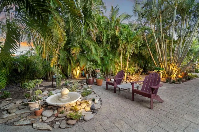 a view of a backyard with furniture and a patio
