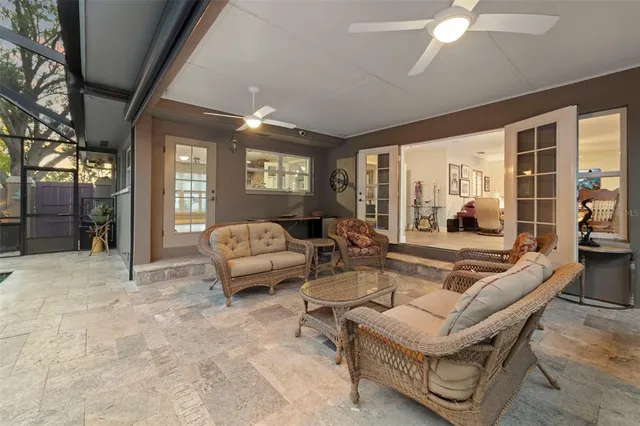 a living room with furniture and floor to ceiling windows