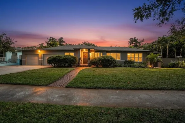 a front view of house with yard and green space