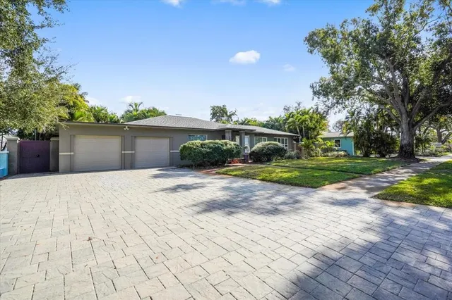 an aerial view of a house with a yard and garden