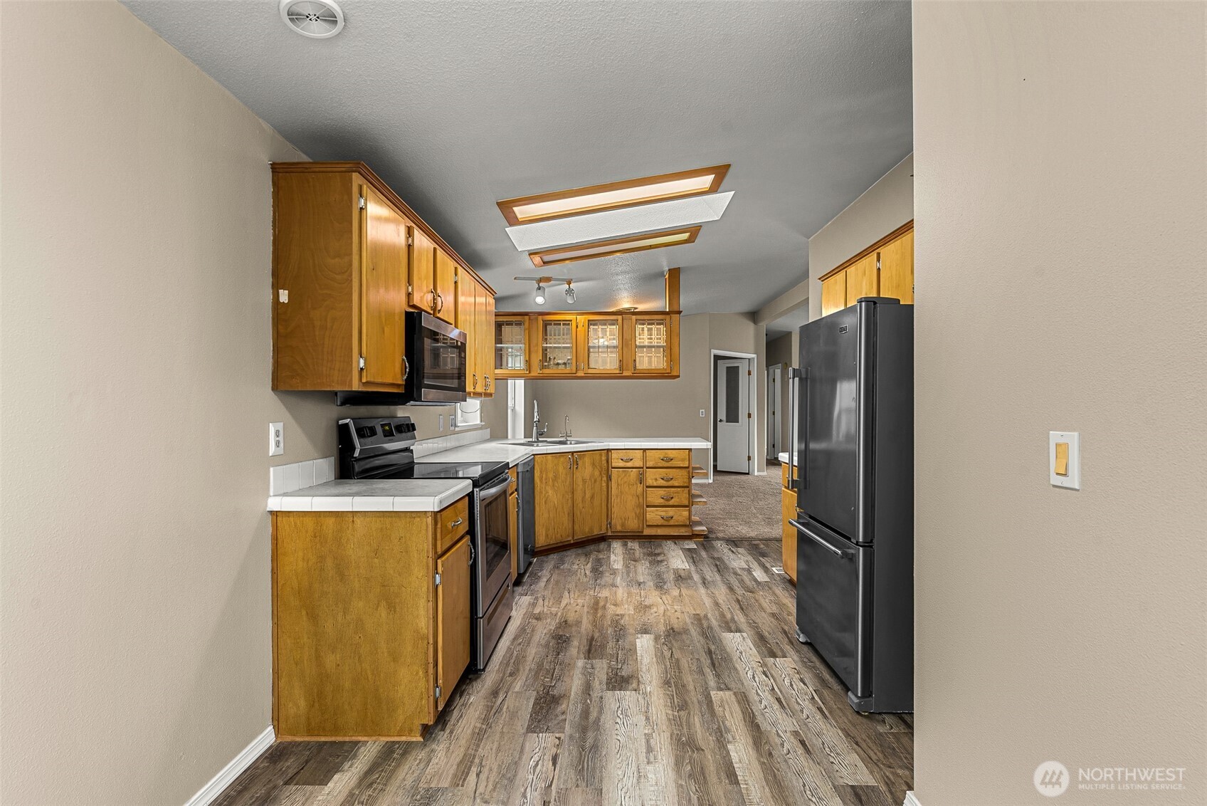 3570 Pinnacle Place Wenatchee, WA 98801 - Photo 12 of 35 a kitchen with stainless steel appliances granite countertop a refrigerator a stove top oven a sink and dishwasher