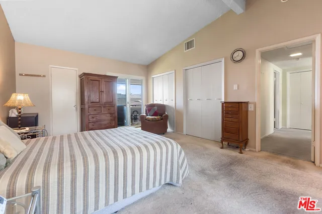 a bedroom with a bed and a large mirror