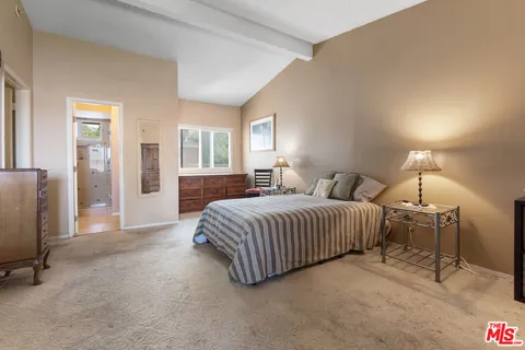 a bathroom with a granite countertop sink a mirror and shower