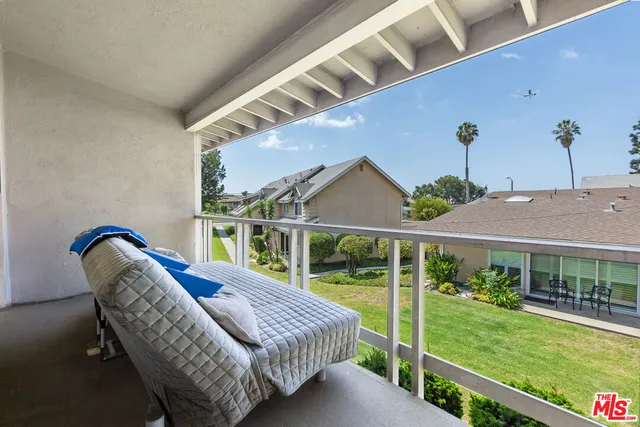 a view of a house with a yard and potted plants