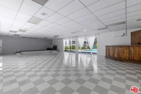 a kitchen with a sink a counter top space cabinets and stainless steel appliances