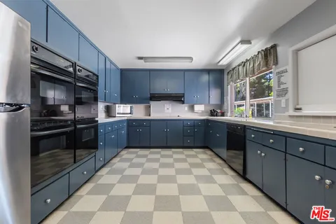 a view of a house with backyard sitting area and garden