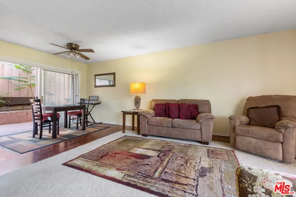 a living room with furniture and a rug