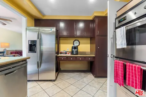 a kitchen with refrigerator and cabinets