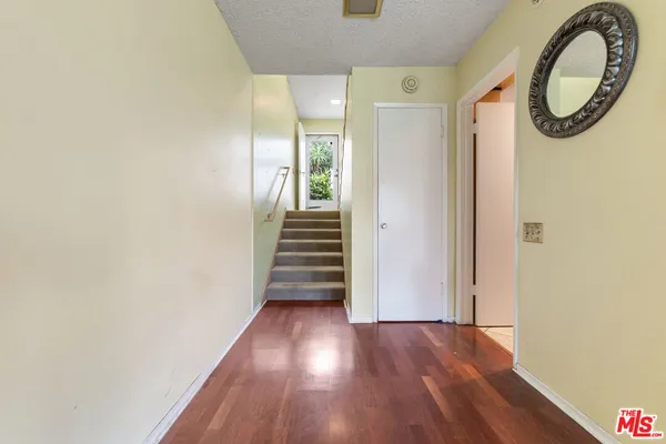 a view of a hallway with wooden floor