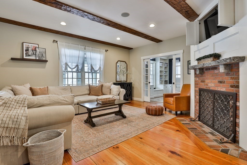 339 Stow Road Harvard, MA 01451 - Photo 17 of 40 a living room with furniture a fireplace and a flat screen tv