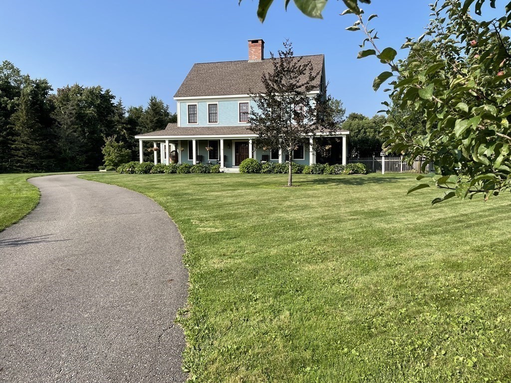 339 Stow Road Harvard, MA 01451 - Photo 2 of 40 a front view of a house with a yard table and chairs