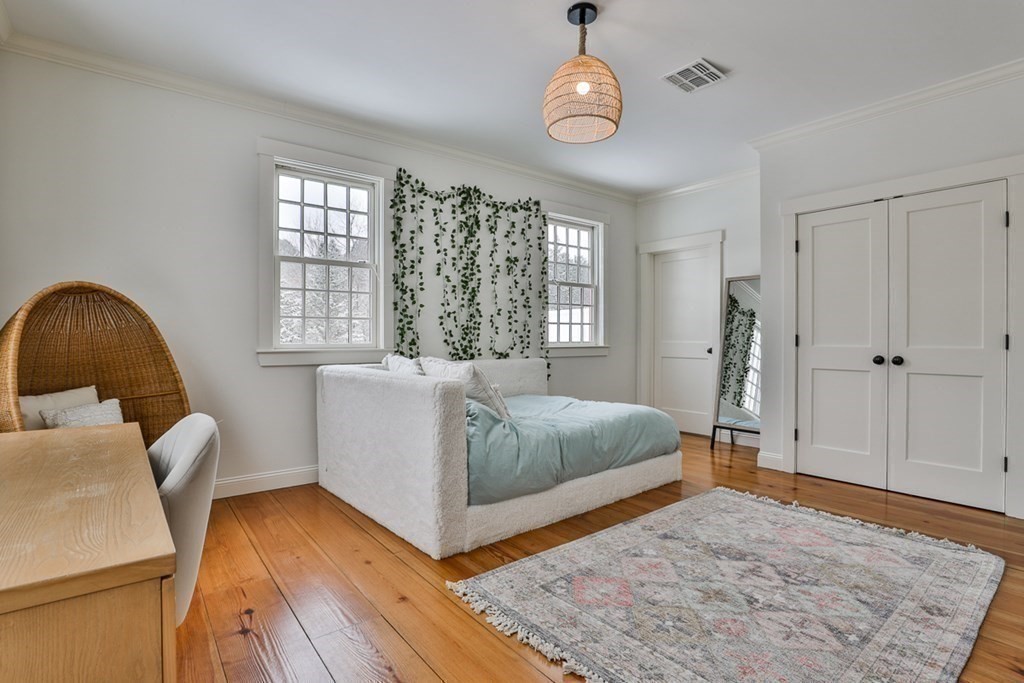 339 Stow Road Harvard, MA 01451 - Photo 24 of 40 a spacious bedroom with a bed and wooden floor