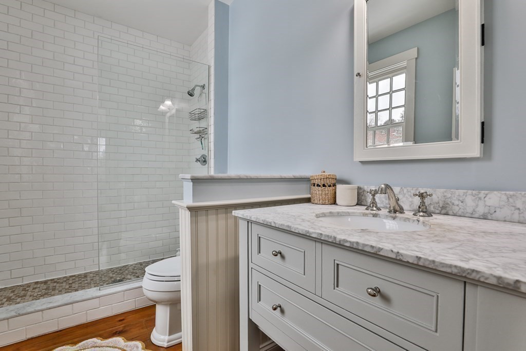 339 Stow Road Harvard, MA 01451 - Photo 25 of 40 a bathroom with a granite countertop toilet sink and mirror