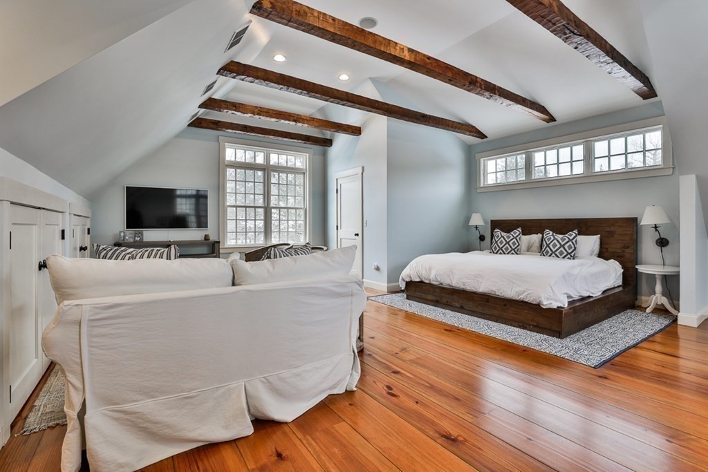 339 Stow Road Harvard, MA 01451 - Photo 29 of 40 a spacious bedroom with a bed and a flat tv screen on dresser