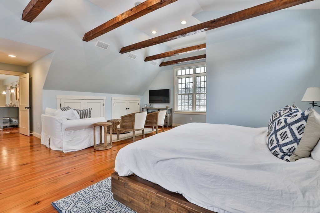 339 Stow Road Harvard, MA 01451 - Photo 30 of 40 a spacious bedroom with a bed and wooden floor