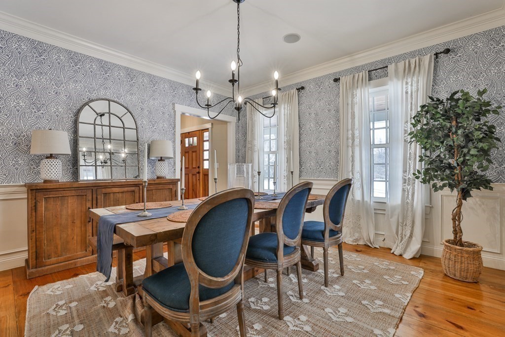339 Stow Road Harvard, MA 01451 - Photo 7 of 40 a dining room with furniture a chandelier and wooden floor