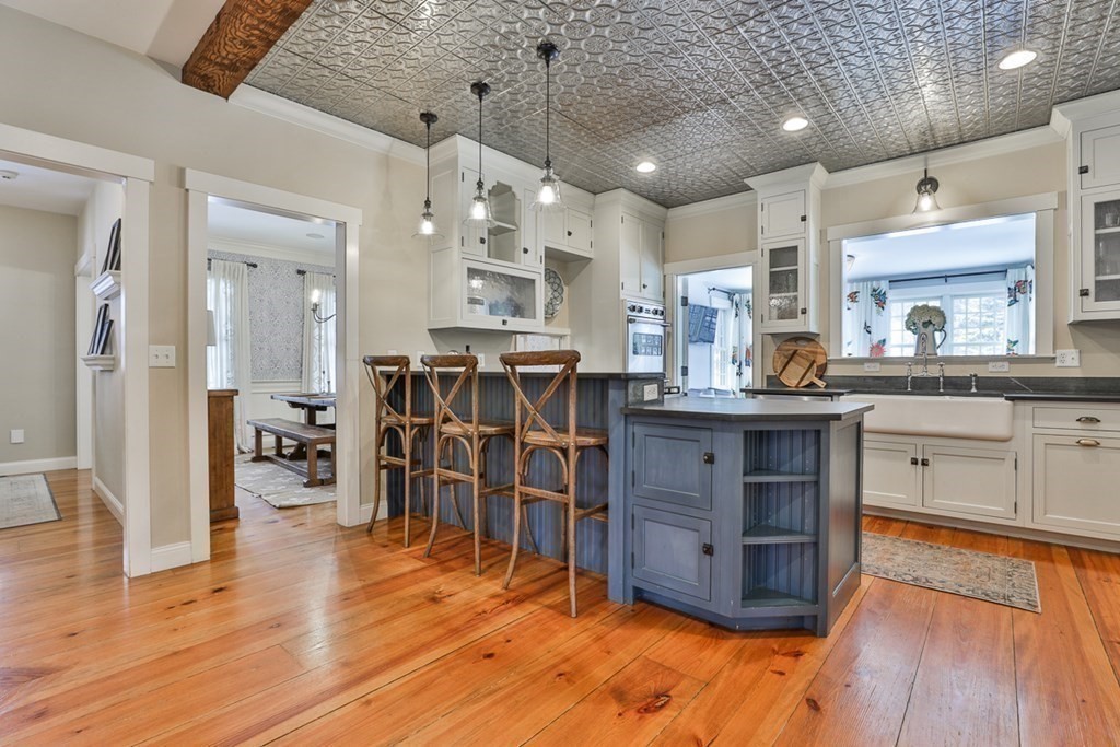 339 Stow Road Harvard, MA 01451 - Photo 8 of 40 a kitchen with stainless steel appliances granite countertop wooden floors and view living room