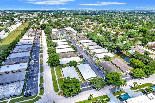 an aerial view of residential houses with outdoor space