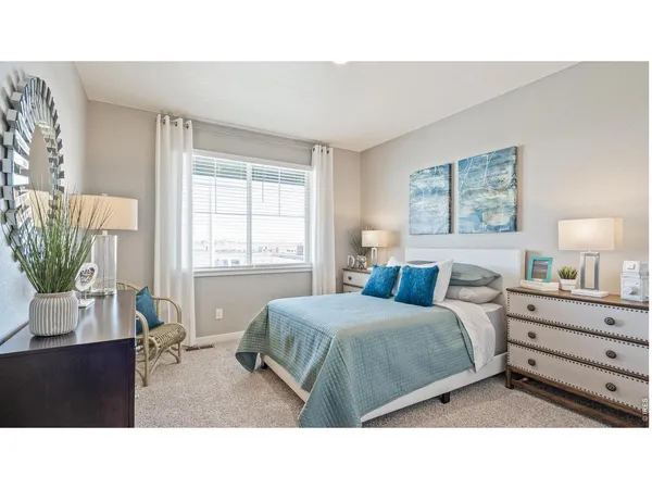 a living room with a bed furniture and a window