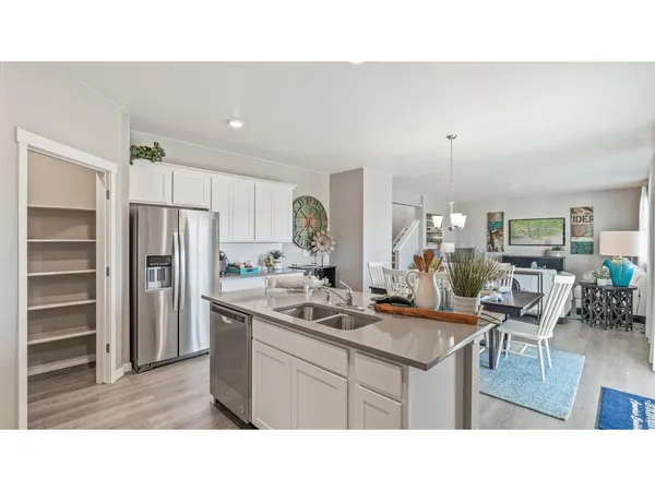 a kitchen with a sink stove and refrigerator