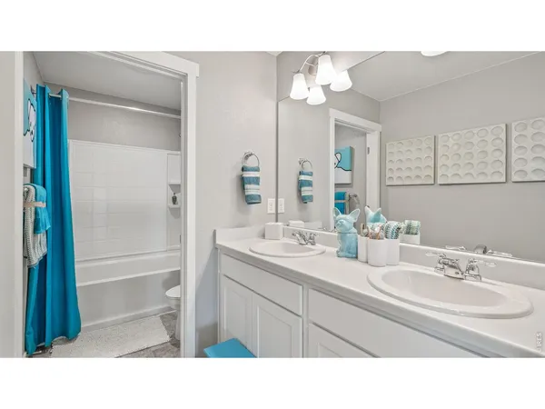 a bathroom with a sink double vanity granite tub shower and a mirror