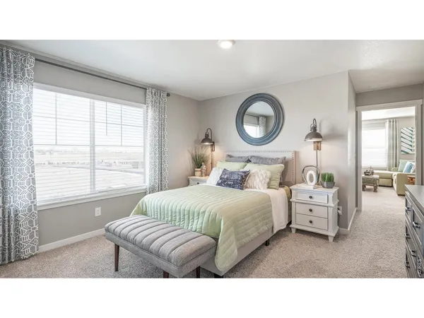 a bedroom with a bed and a large window