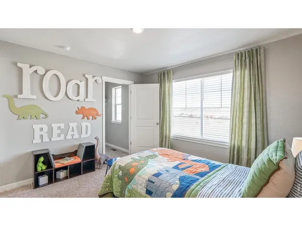 a bedroom with a bed a mirror and a window