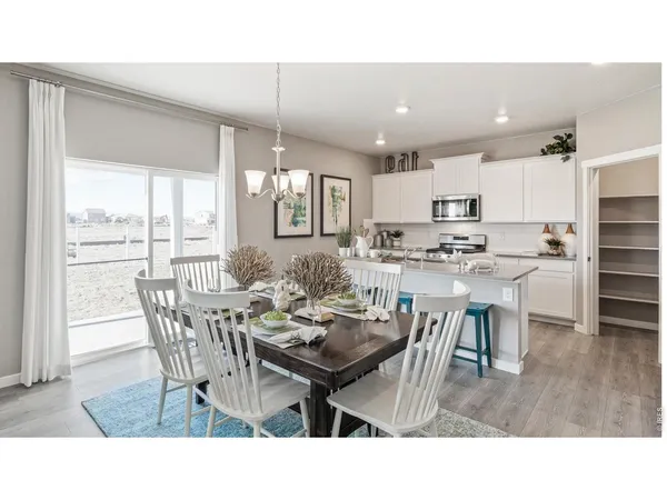 a dining room with kitchen island a table and chairs