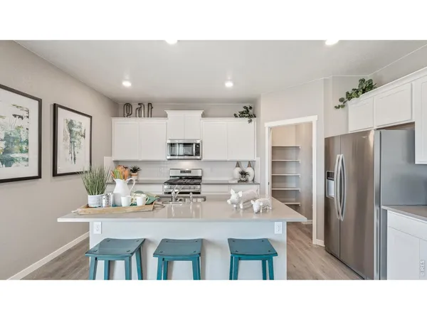 a kitchen with a table and chairs