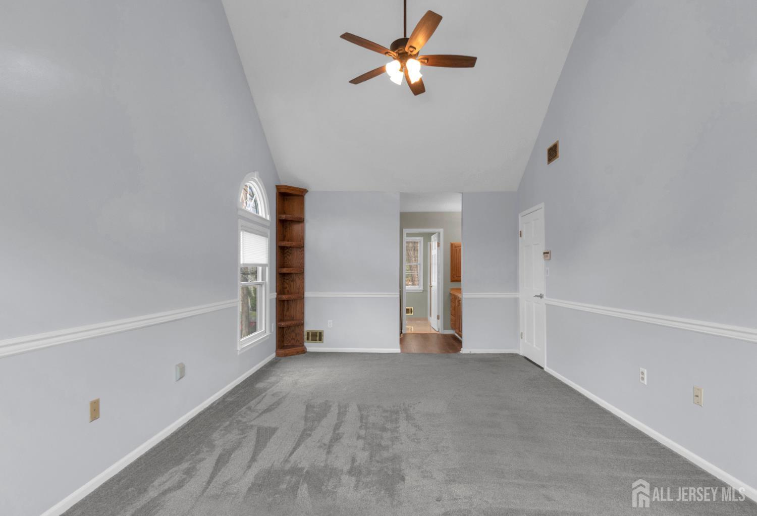 27 Oakland Road Old Bridge, NJ 08857 - Photo 19 of 39 a view of empty room with wooden floor and fan