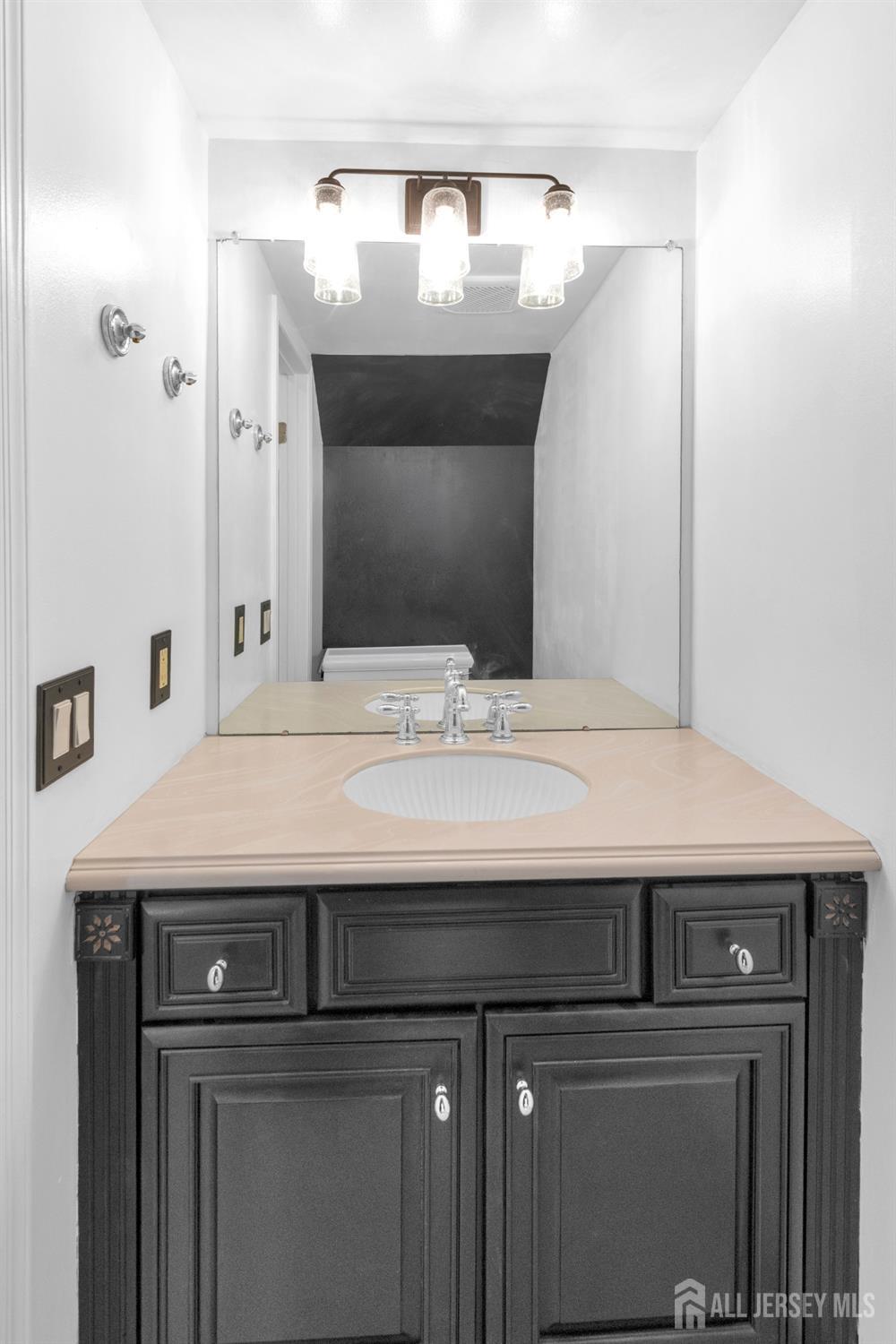 27 Oakland Road Old Bridge, NJ 08857 - Photo 22 of 39 a bathroom with a sink and a mirror