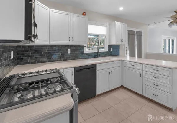an open kitchen with cabinets and stainless steel appliances
