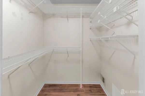 a view of a hallway with wooden floor and a porch