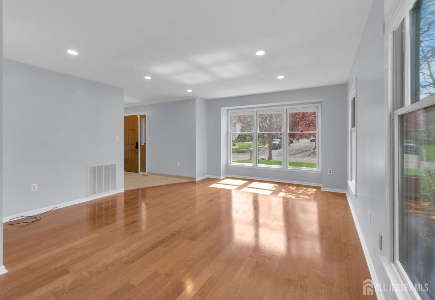27 Oakland Road Old Bridge, NJ 08857 - Photo 31 of 39 a view of an empty room with wooden floor and a window