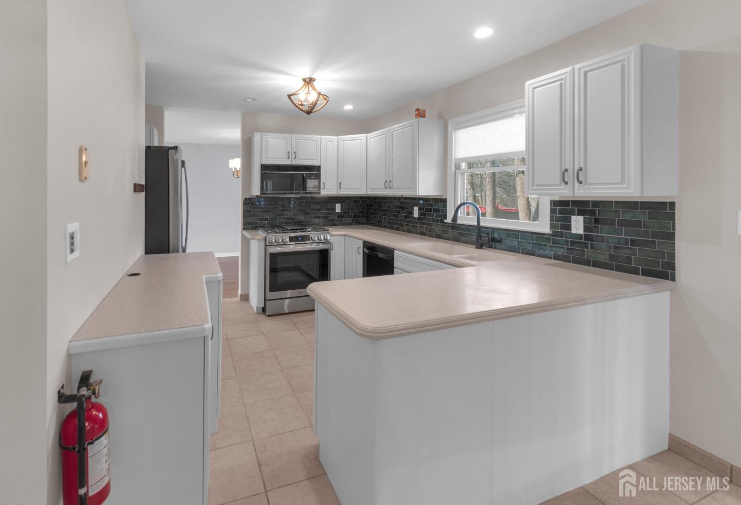 27 Oakland Road Old Bridge, NJ 08857 - Photo 33 of 39 an open kitchen with cabinets and stainless steel appliances