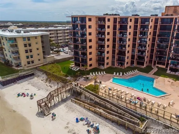 a view of a pool with wooden bench