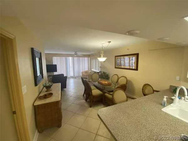 a kitchen with a sink a refrigerator and cabinets