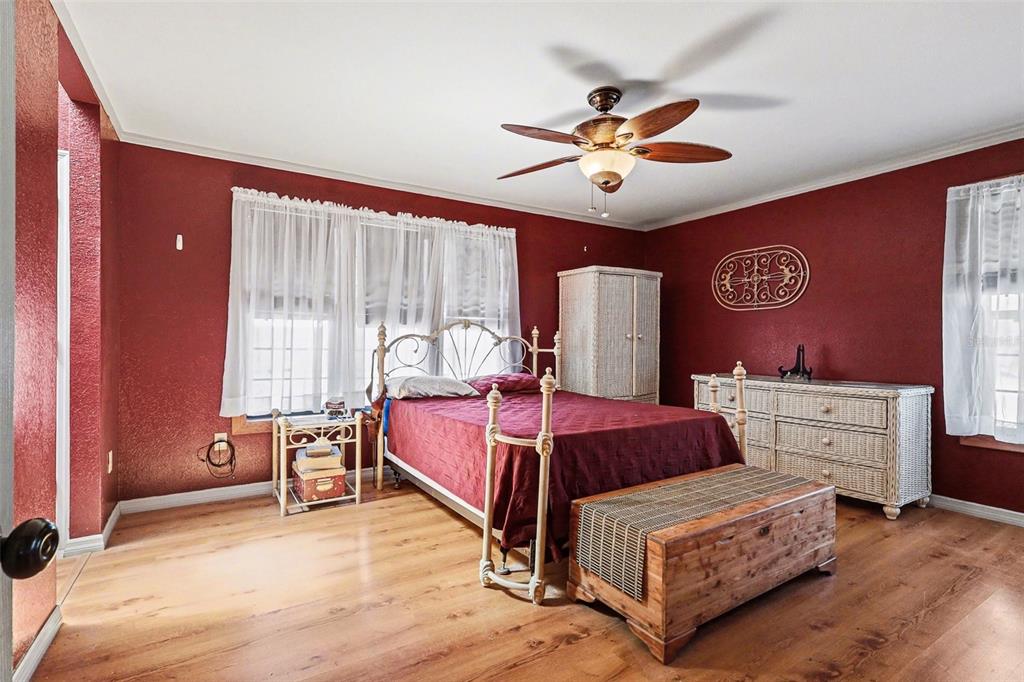 58 Deer Road Frostproof, FL 33843 - Photo 12 of 20 a bedroom with a bed and a chandelier