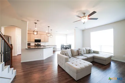 a living room with furniture and kitchen view