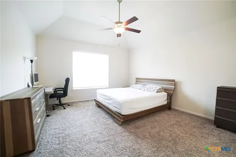 a bedroom with a bed and a table