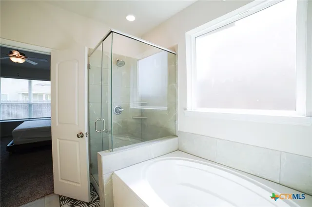 a bathroom with a bathtub and a shower