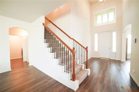 a view of entryway and hall with wooden floor