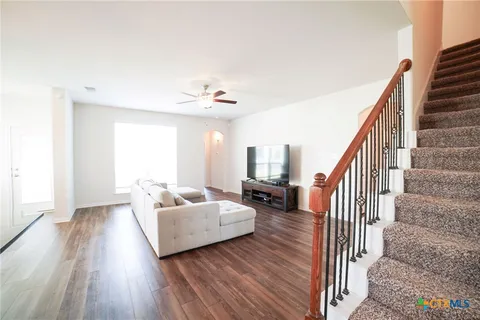 a living room with furniture and a wooden floor