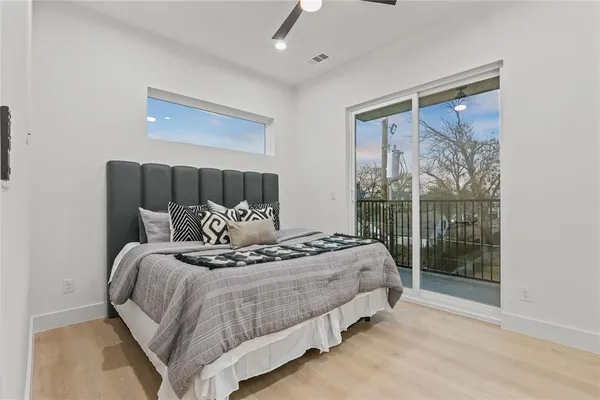 a large bed sitting in a bedroom next to a window