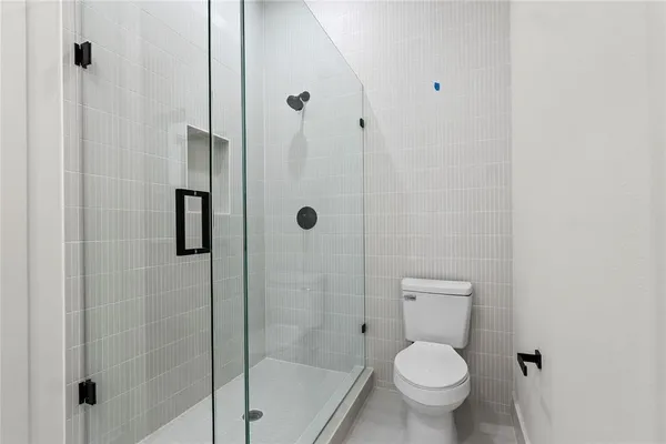 a a bathroom with a toilet and shower