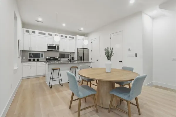 a kitchen with appliances a sink and cabinets