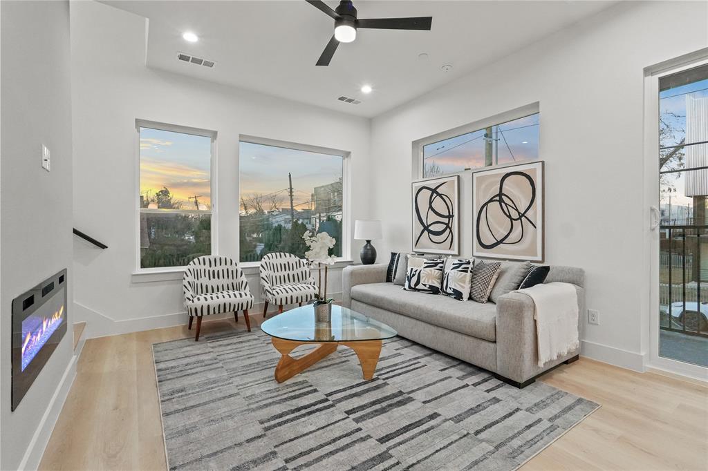 2031 North Prairie Avenue, Unit 101 Dallas, TX 75204 - Photo 9 of 23 Living area with a glass covered fireplace, ceiling fan, light wood finished floors, and recessed lighting