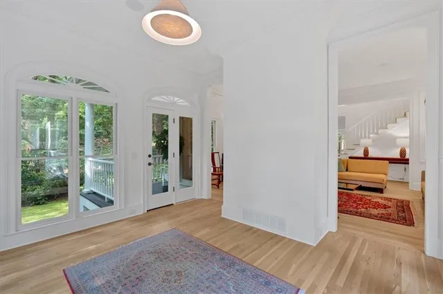 a spacious bathroom with a double vanity sink a toilet a mirror and shower