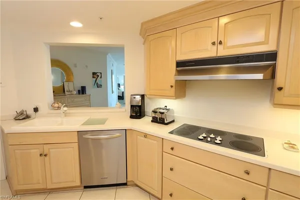 a kitchen with white cabinets and appliances