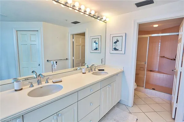 a bathroom with a sink double vanity and a mirror
